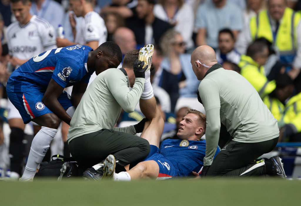 Liam Delap receives treatment from Chelsea's medical staff after picking up an injury against Fulham in the Premier League.