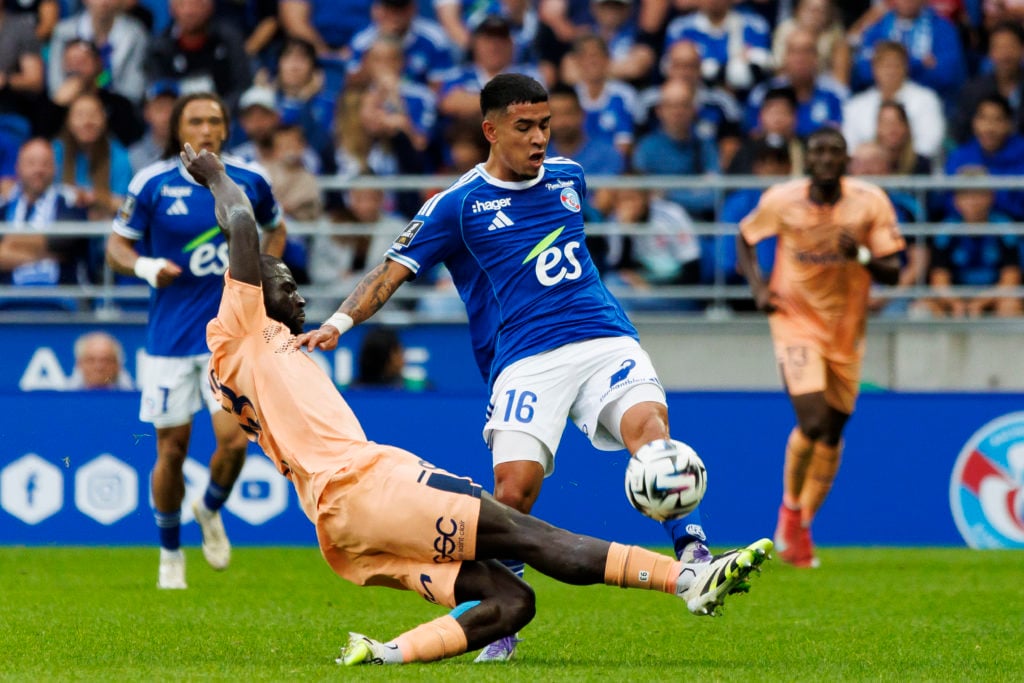 Kendry Paez of Strasbourg challenged by Le Havre's Arouna Sangante during a Ligue 1 match.