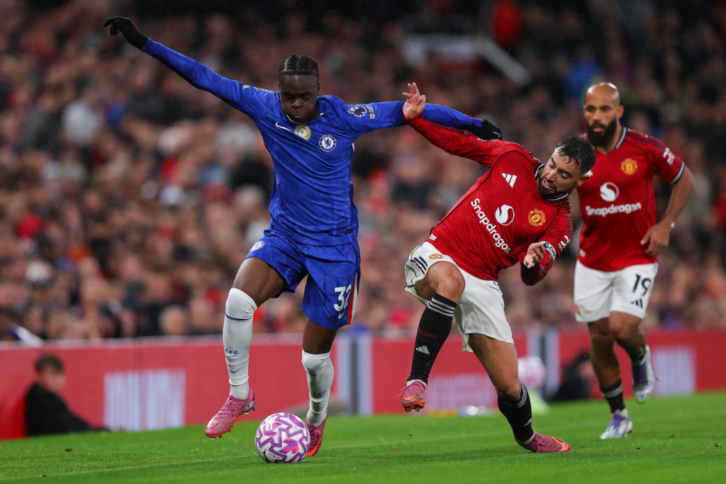 Chelsea's Tyrique George battles with Manchester United's Bruno Fernandes during a Premier League match.