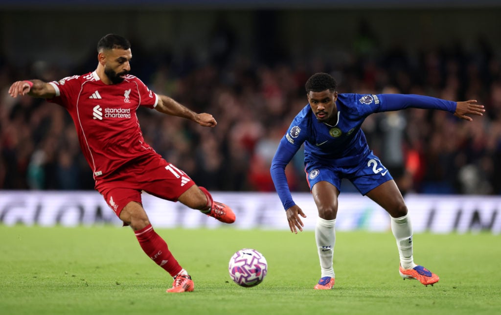 Liverpool's Mohamed Salah battling with Chelsea's Jorrel Hato in the Premier League fixture.