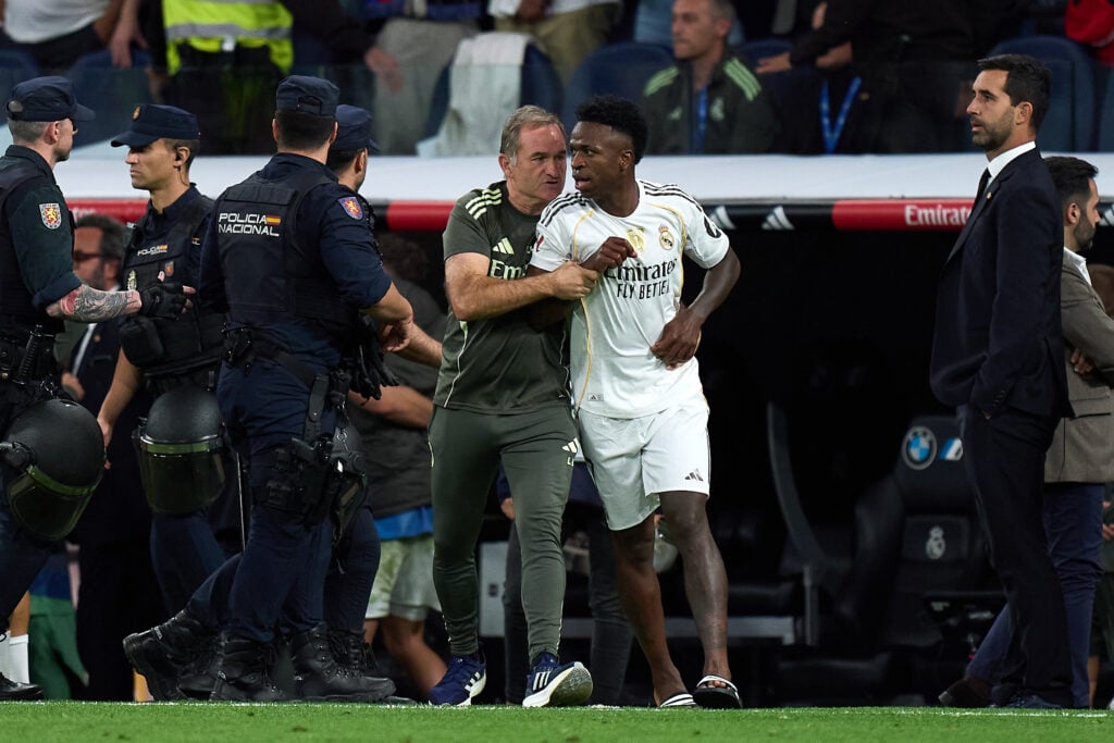 Vinicius Jr is escorted off the pitch during Real Madrid vs Barcelona