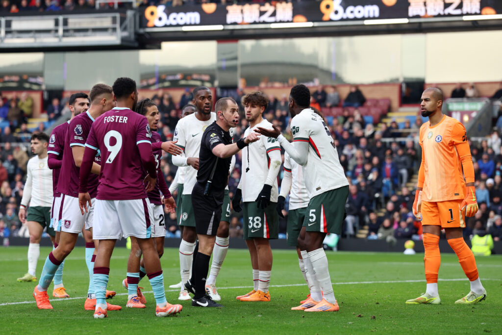 Peter Bankes shows a yellow card to Benoit Badiashile during Burnley v Chelsea - Premier League