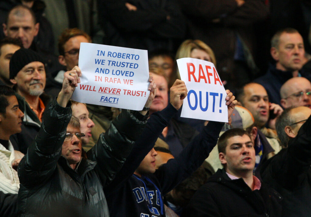Chelsea fan holding a sign in condemnation of Rafa Benitez