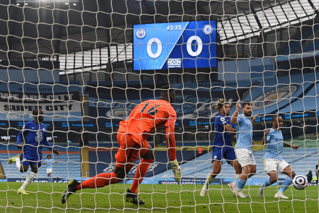 Manchester City's English midfielder Raheem Sterling (R) prepares to shoot