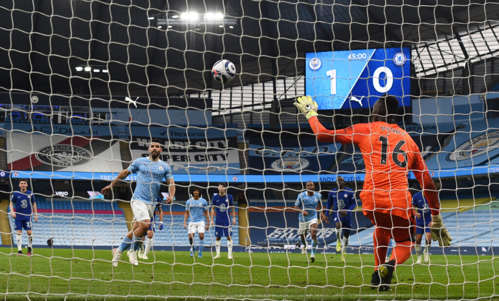 Sergio Aguero of Manchester City takes a penalty that is saved by Edouard Mendy of Chelsea