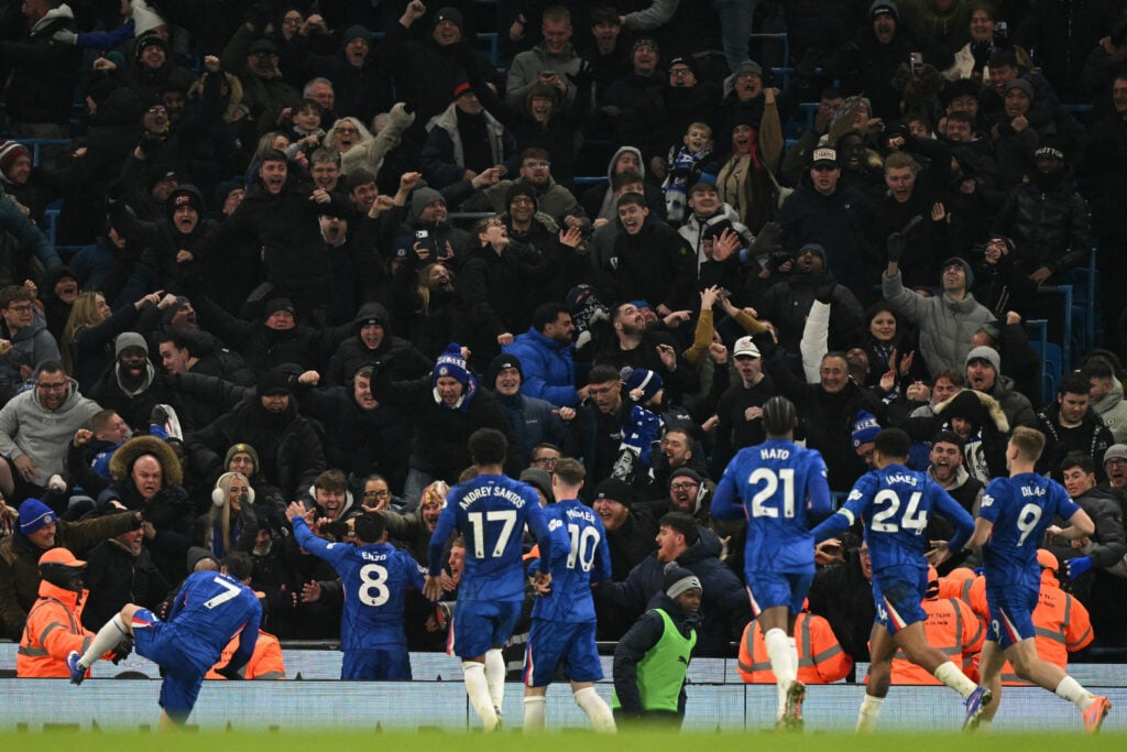 Chelsea's Argentinian midfielder #08 Enzo Fernandez (L) celebrates in front of Chelsea fans
