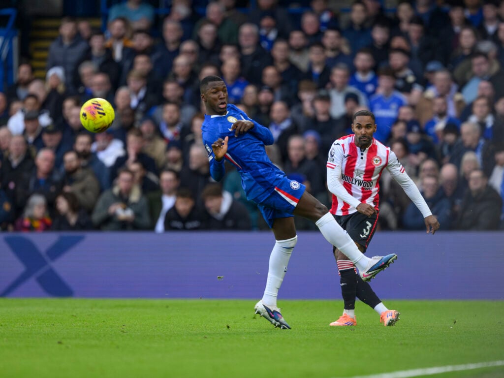 Brentford's Rico Henry (right) crosses the ball despite the attentions of Chelsea's Moises Caicedo (left)