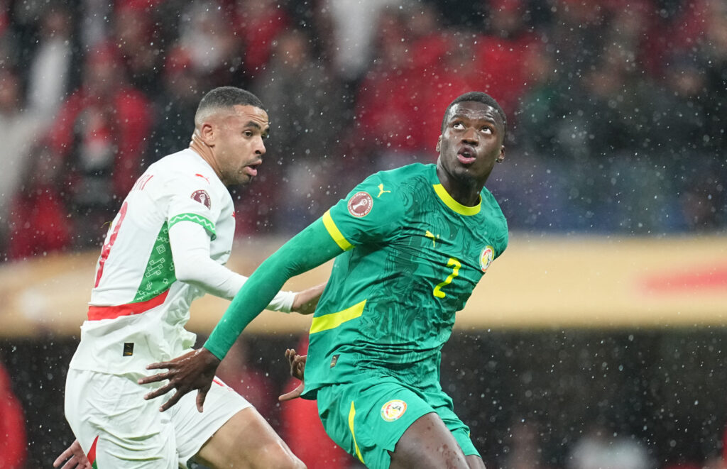 Ayoub El Kaabi of Morocco and Mamadou Sarr of Senegal battle for the ball