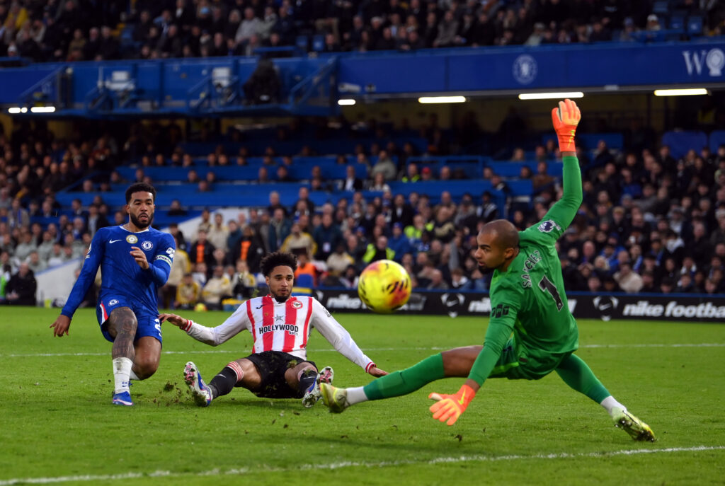 Robert Sanchez of Chelsea saves from Kevin Schade of Brentford