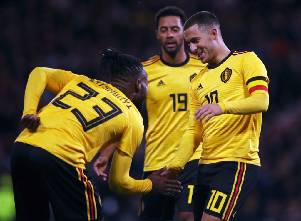 Michy Batshuayi of Belgium celebrates scoring a goal with team mates Eden Hazard and Mousa Dembele