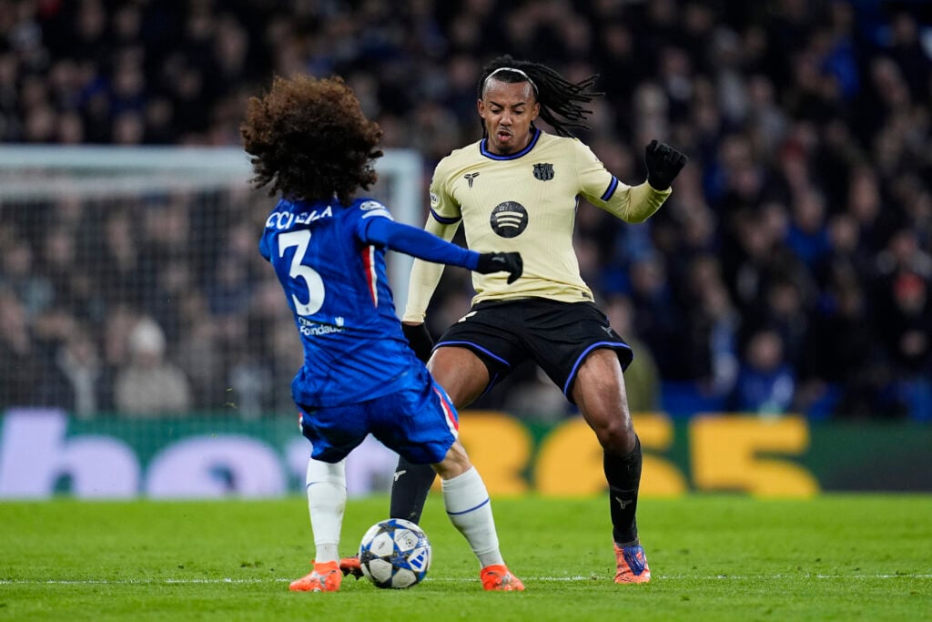 Jules Kounde of FC Barcelona and Marc Cucurella of Chelsea FC compete for the ball