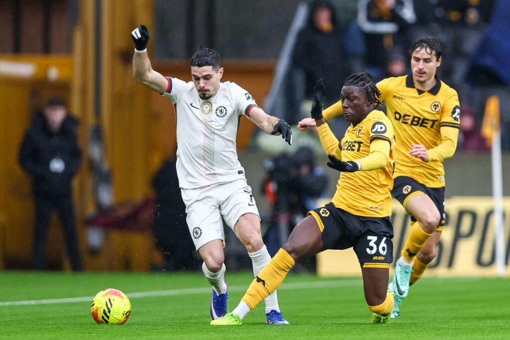 Mateus Mane of Wolverhampton Wanderers gets a toe to the ball as he battles for possession with Pedro Neto of Chelsea FC
