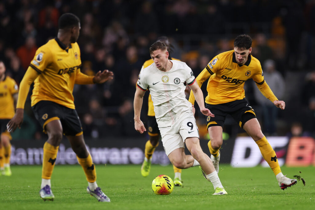 Liam Delap of Chelsea is challenged by Santiago Bueno of Wolverhampton Wanderers
