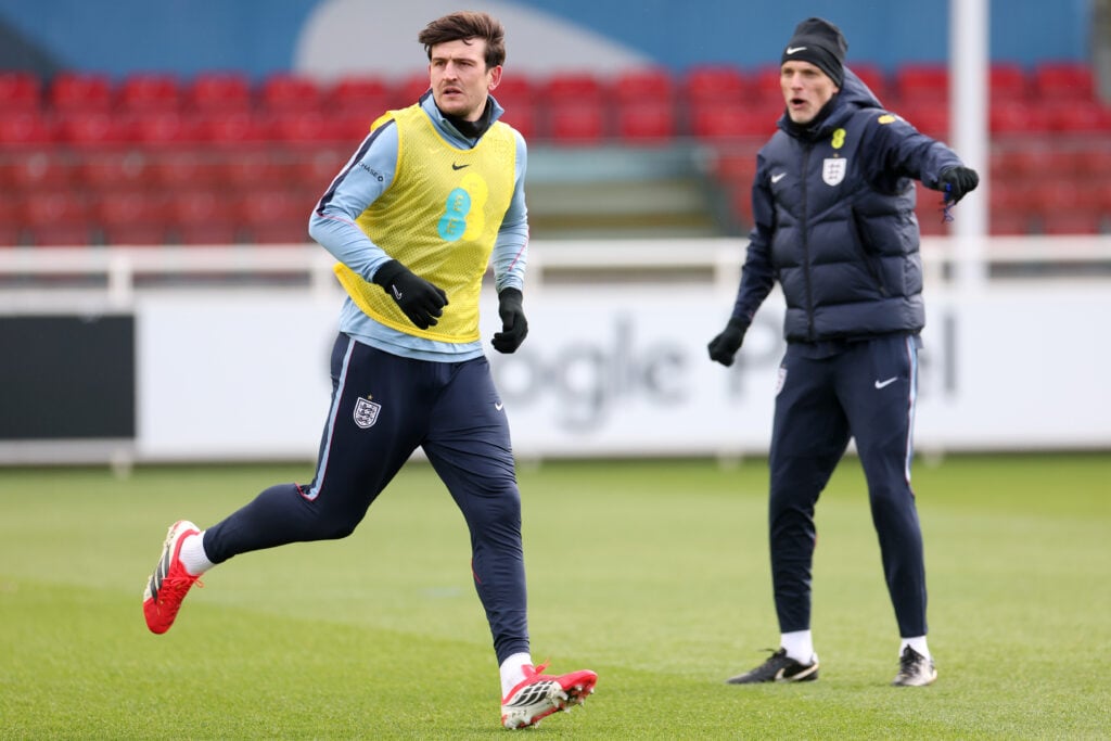 Harry Maguire of England runs as Thomas Tuchel, Head Coach of England, reacts