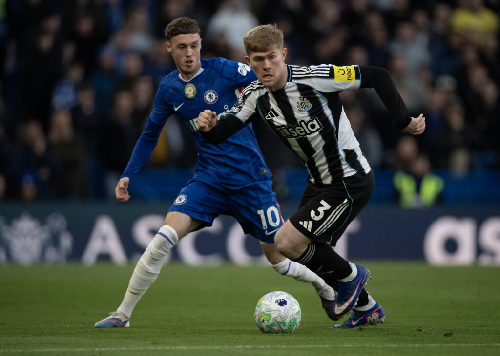 Lewis Hall of Newcastle United (R) in action with Cole Palmer of Chelsea (L)