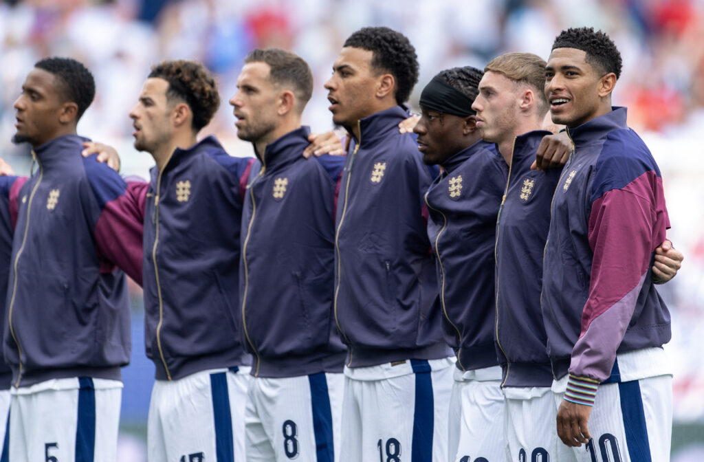 Jude Bellingham of England lines up with team mates Cole Palmer, Noni Madueke, Morgan Rogers, Jordan Henderson, Curtis Jones and Ezri Konsa