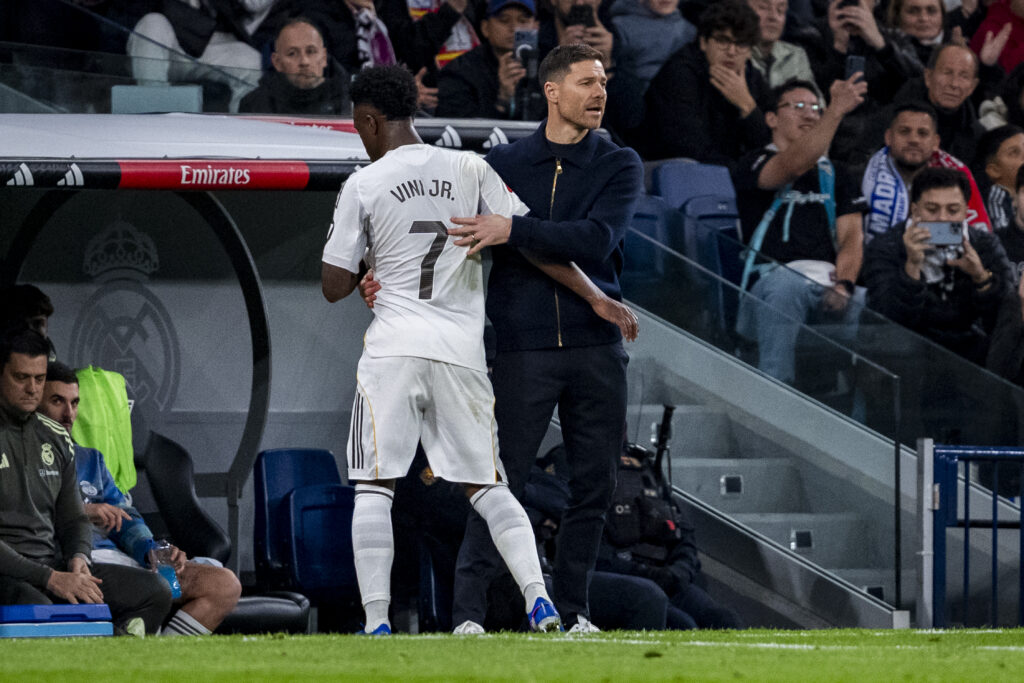Vinicius Junior of Real Madrid hugs Xabi Alonso