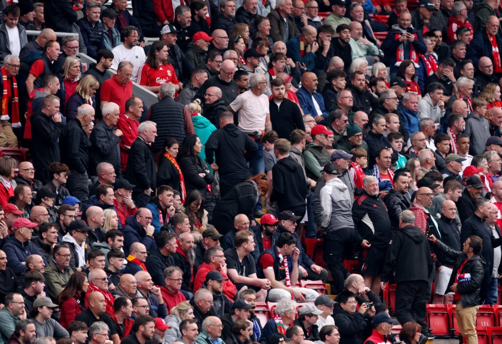 Fans of Liverpool leave the stadium
