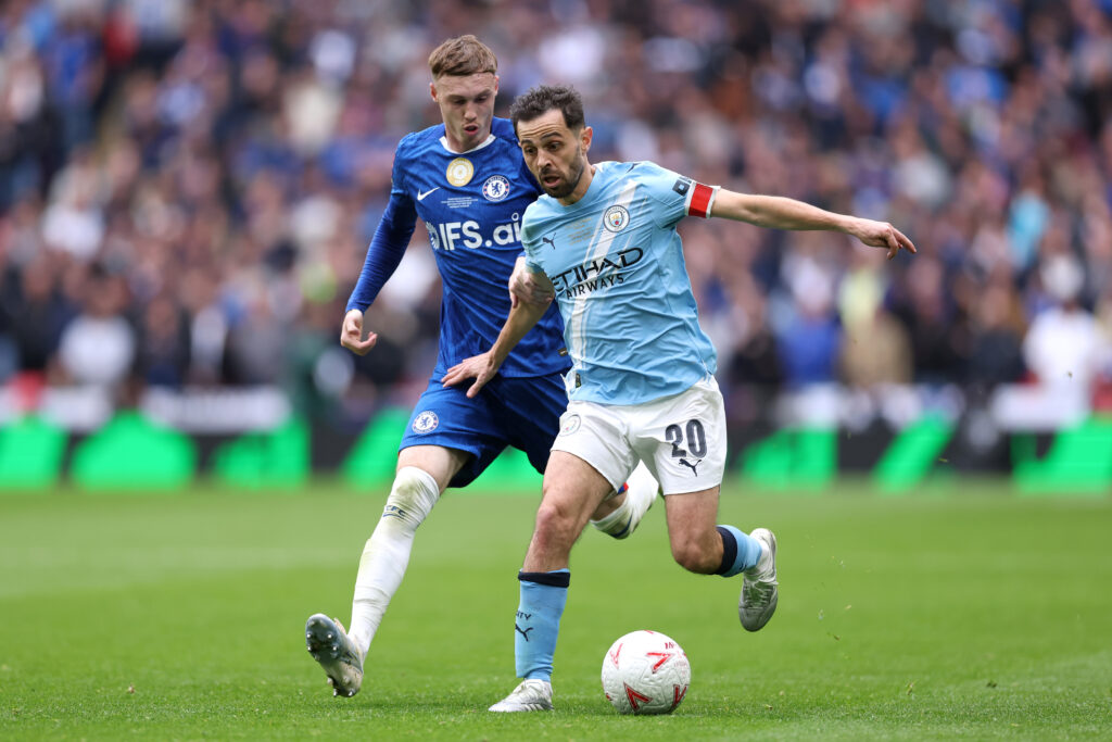 Bernardo Silva of Manchester City takes on Cole Palmer of Chelsea