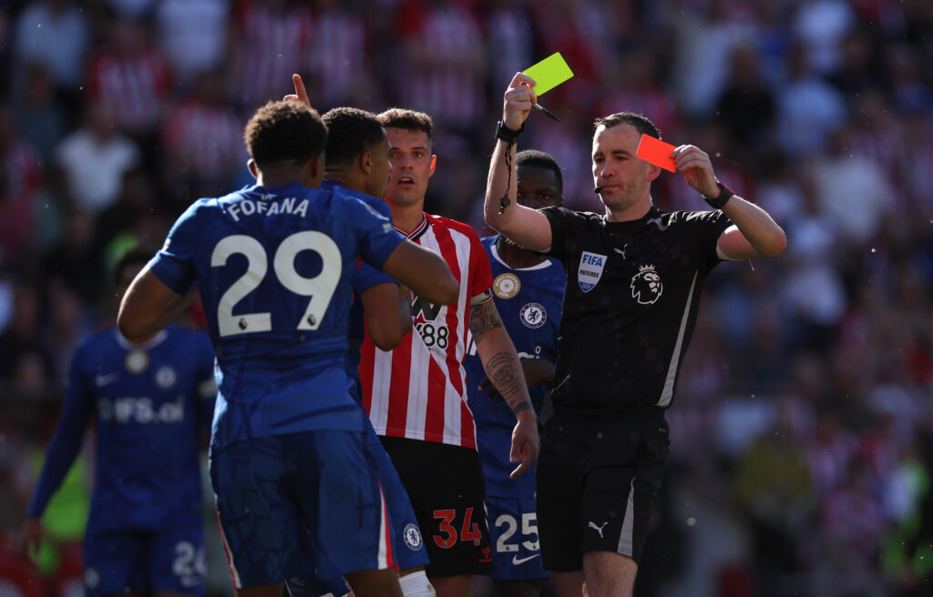 Chris Kavanagh shows Wesley Fofana of Chelsea a second yellow card