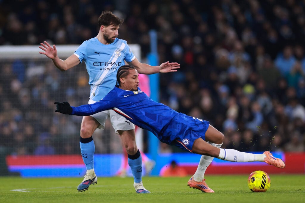 Joao Pedro of Chelsea under pressure from Ruben Dias