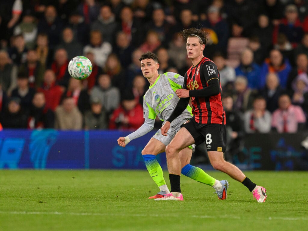 Bournemouth's Alex Scott (right) battles with Manchester City's Phil Foden