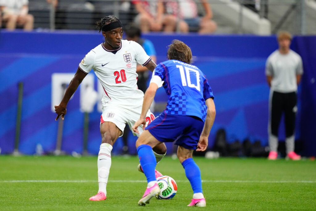 Noni Madueke (20) of England drives the ball against Luka Modric