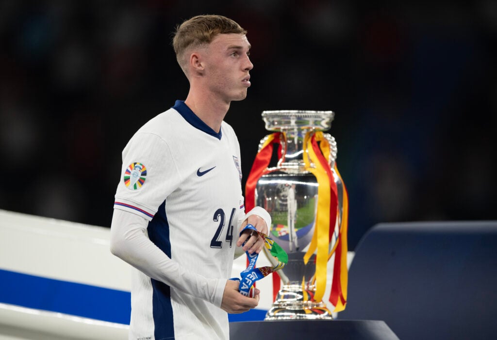 Cole Palmer of England walks past the trophy