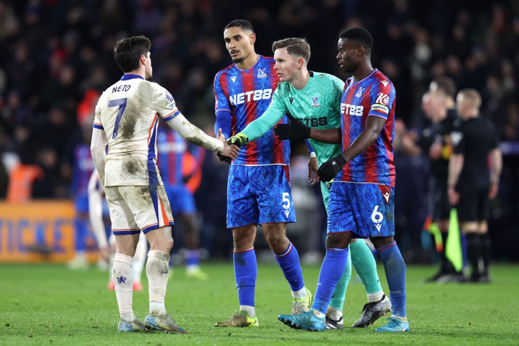 Pedro Neto of Chelsea shakes hands with Crystal Palace goalkeeper Dean Henderson as Maxence Lacroix and Marc Guehi wait their turn