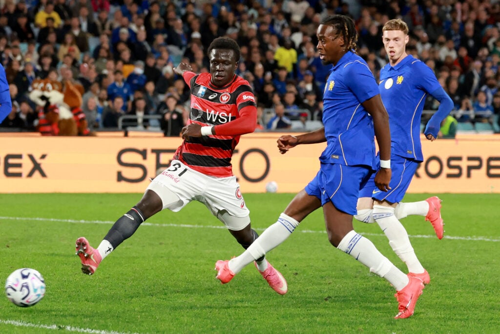 Chelsea's Jamie Gittens (2nd R) shoots past Wanderers' Atiya Waraga (L) to score a goal